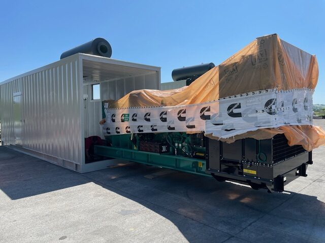 Generator set being loaded into an acoustic enclosure